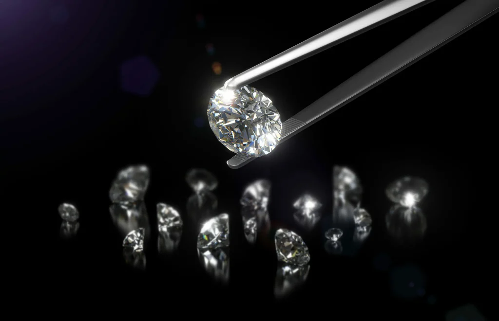 Diamond between tweezers on a black background